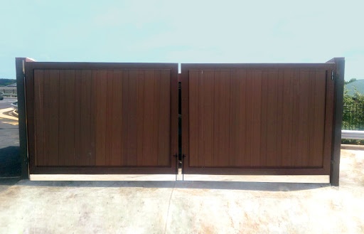 A brown wood grain Composite Dumpster Gate has one latch down the center for easy and frequent access. A brown wood grain Composite Dumpster Gate has one latch down the center for easy and frequent access.