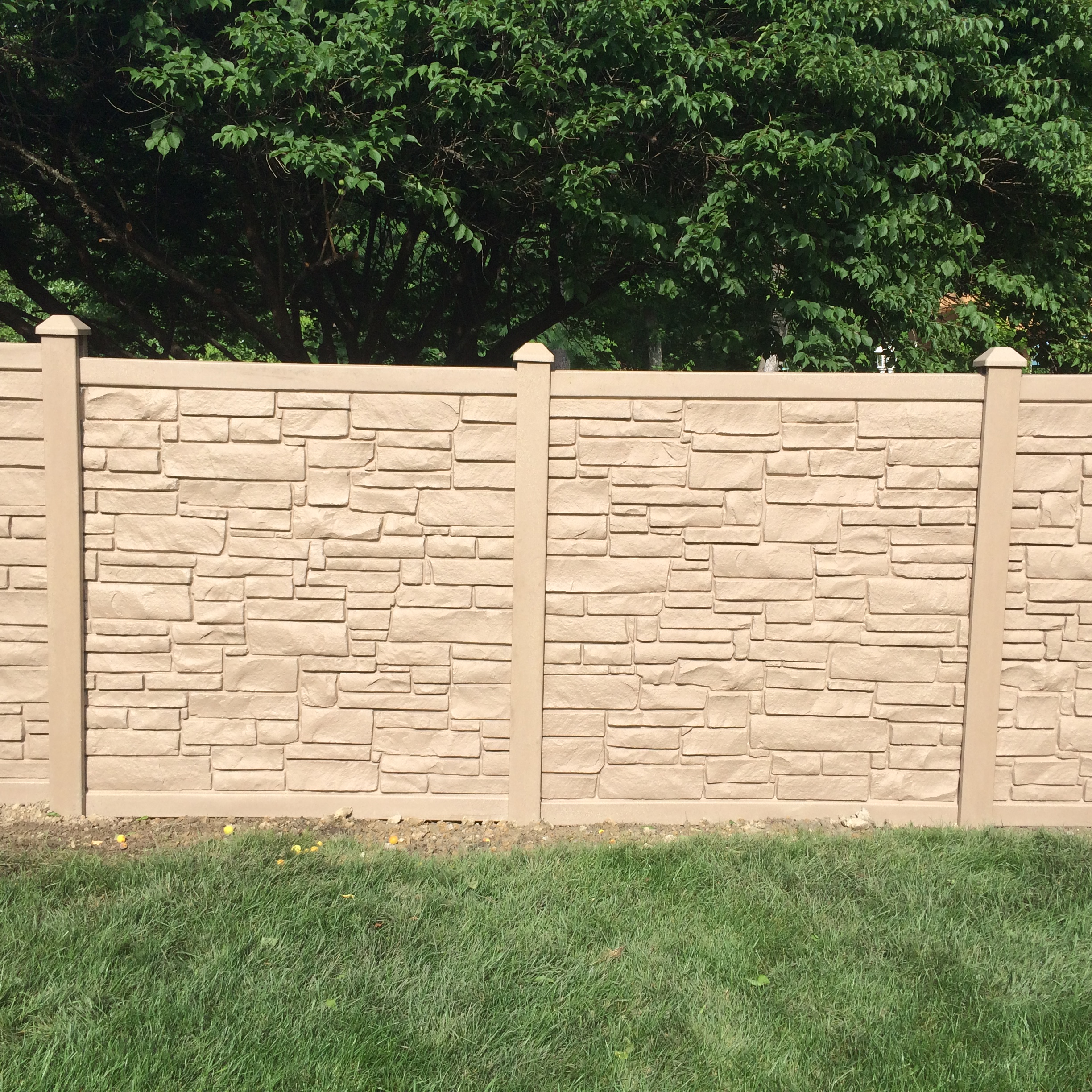 Ecostone Simulated Wood Fence Installaion in Norfolk VA adds a brick feel to a vinyl fence.