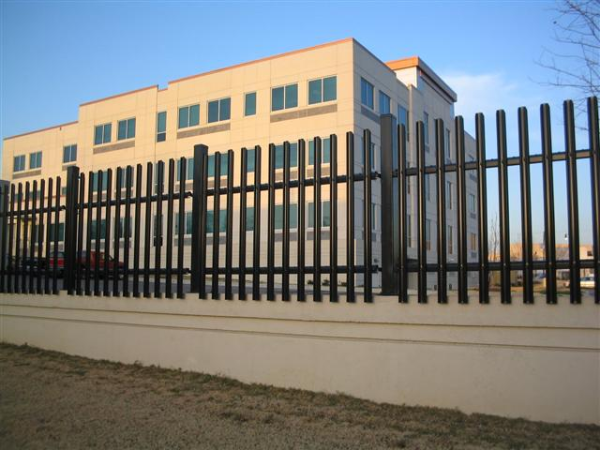 A building under renovation uses ameristar black galvanized steel with sharp picket points to deter access to the area