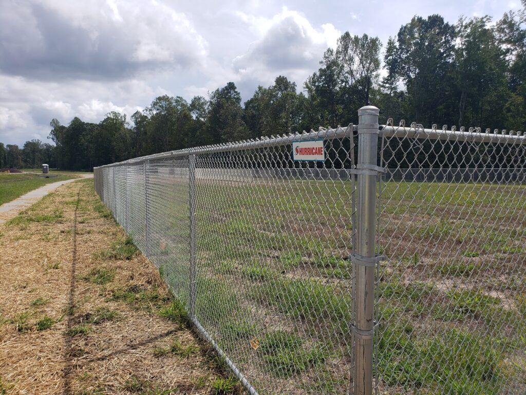 chain link fence along a walking path.